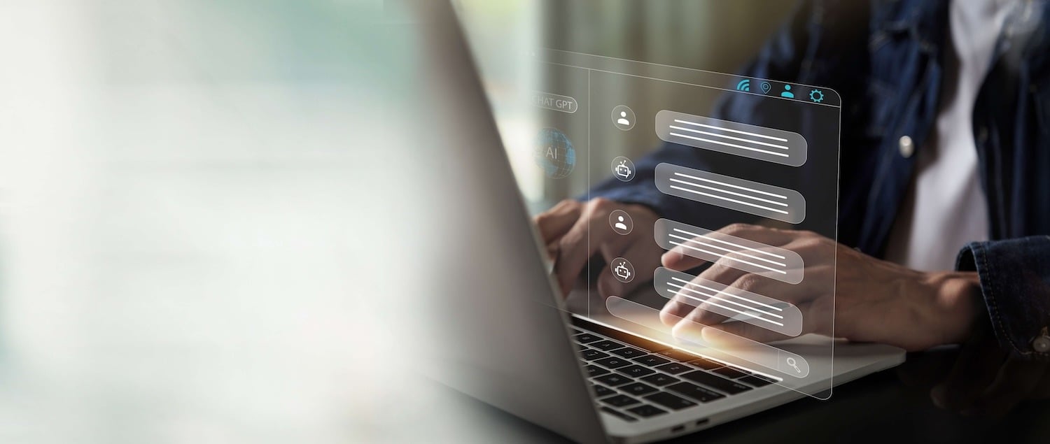 Person typing on a laptop with a digital chat interface overlay.